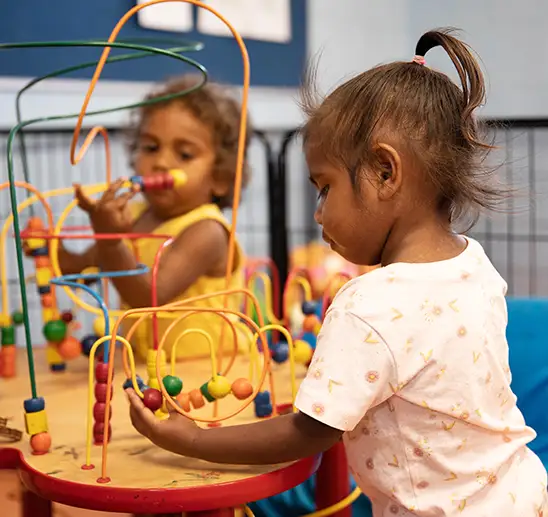 Two Indigenous toddlers playing at a early education centre