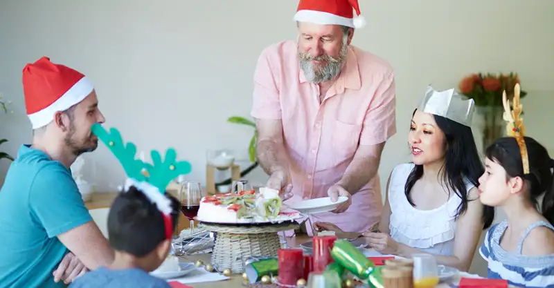 A happy family having dessert together on Christmas.