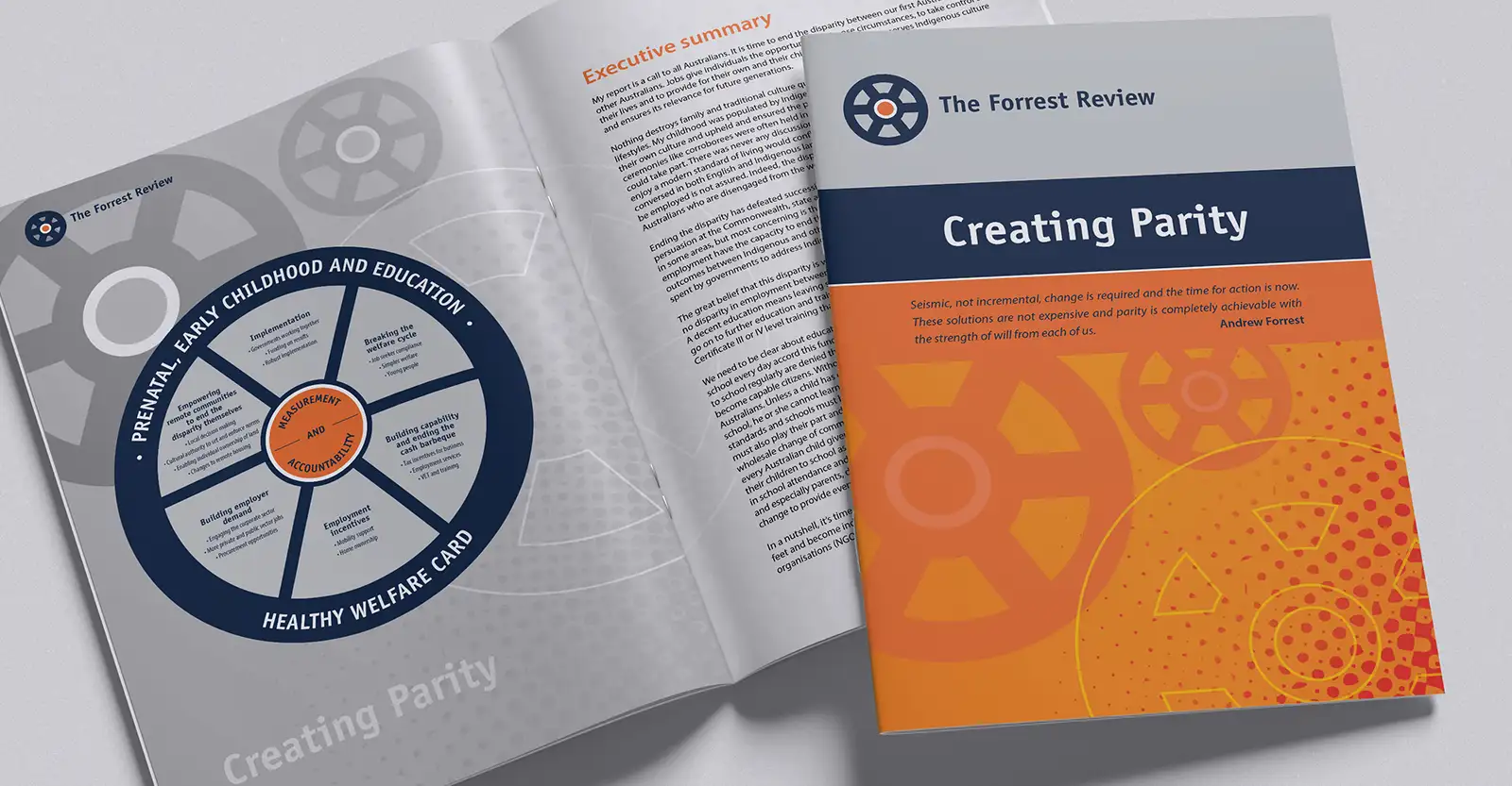 A copy of the Creating Parity report lies open on a page that has a graphic of a prenatal, early childhood and education score card. On top of this open report is another that is closed, showing the report's cover.